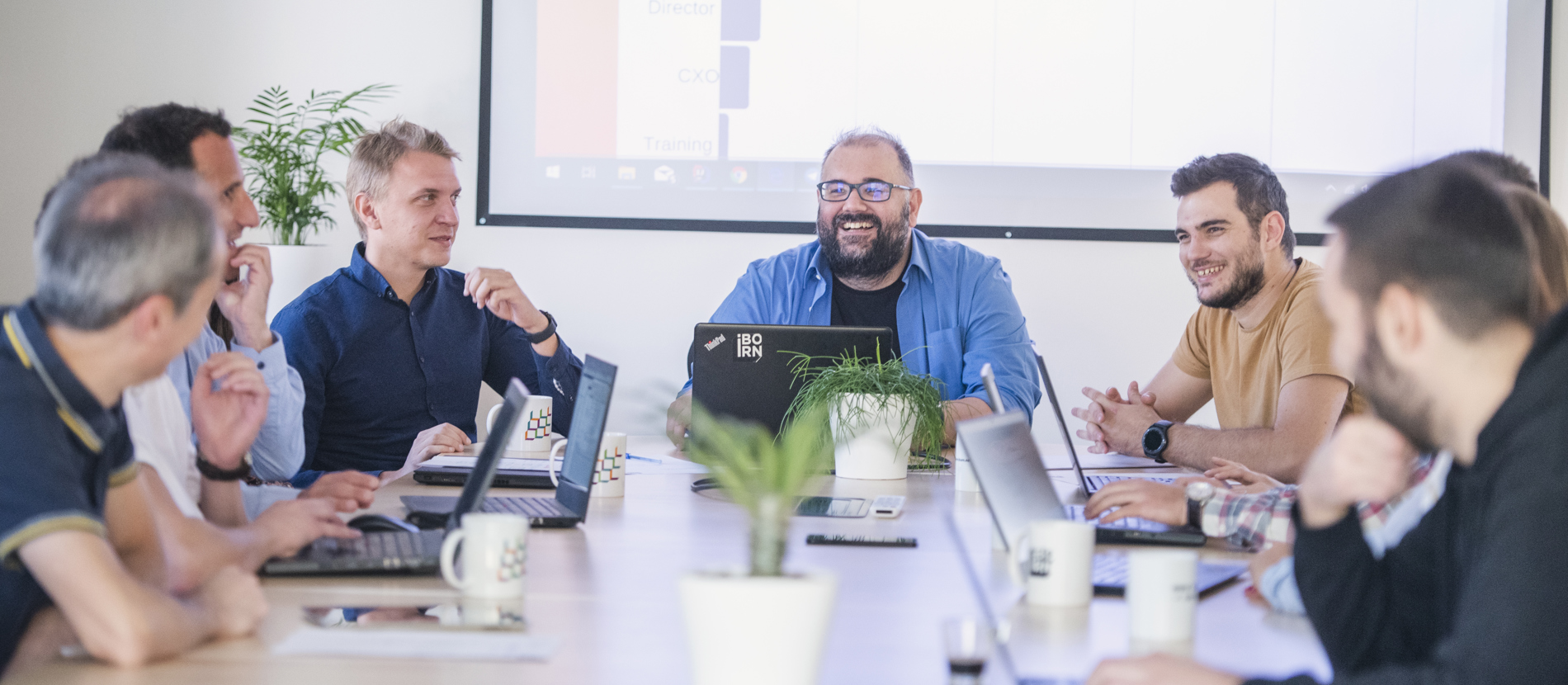 Group of data engineers working together in a bright office.