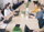 A team of professionals working together at a table, using laptops to accomplish tasks.