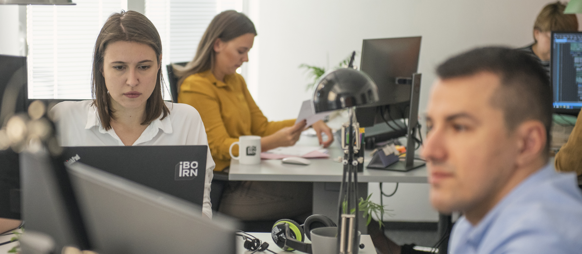 Two machine learning engineers working on a laptop. 