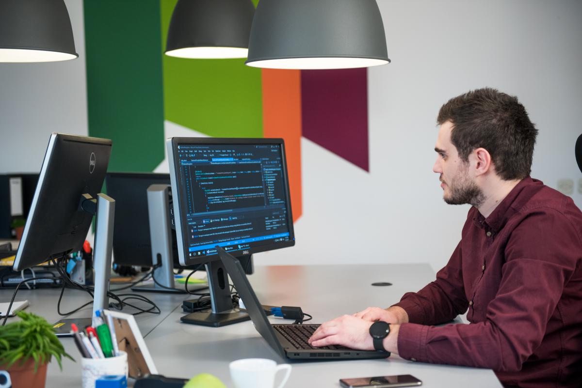 Software engineer working on his laptop.