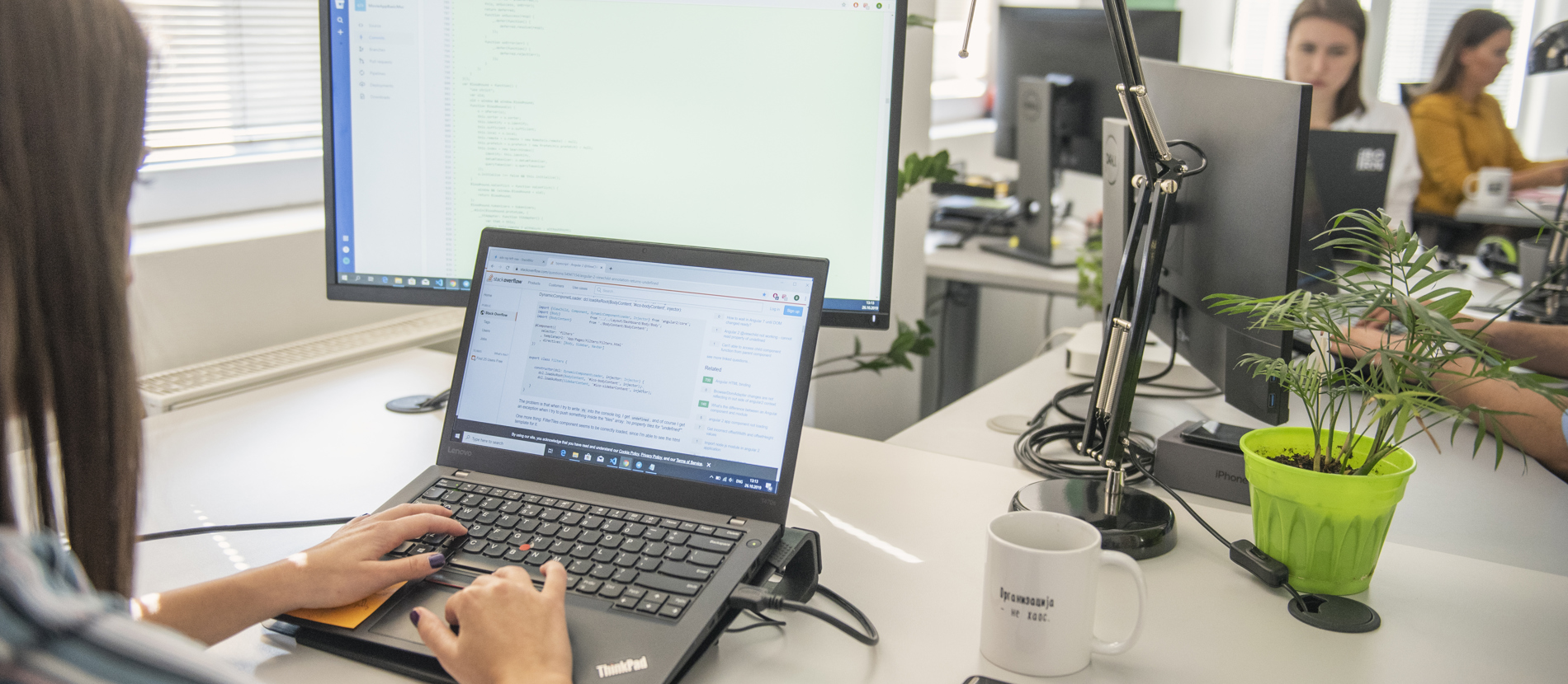 Software engineers working at their desks focused on computers and monitors. 