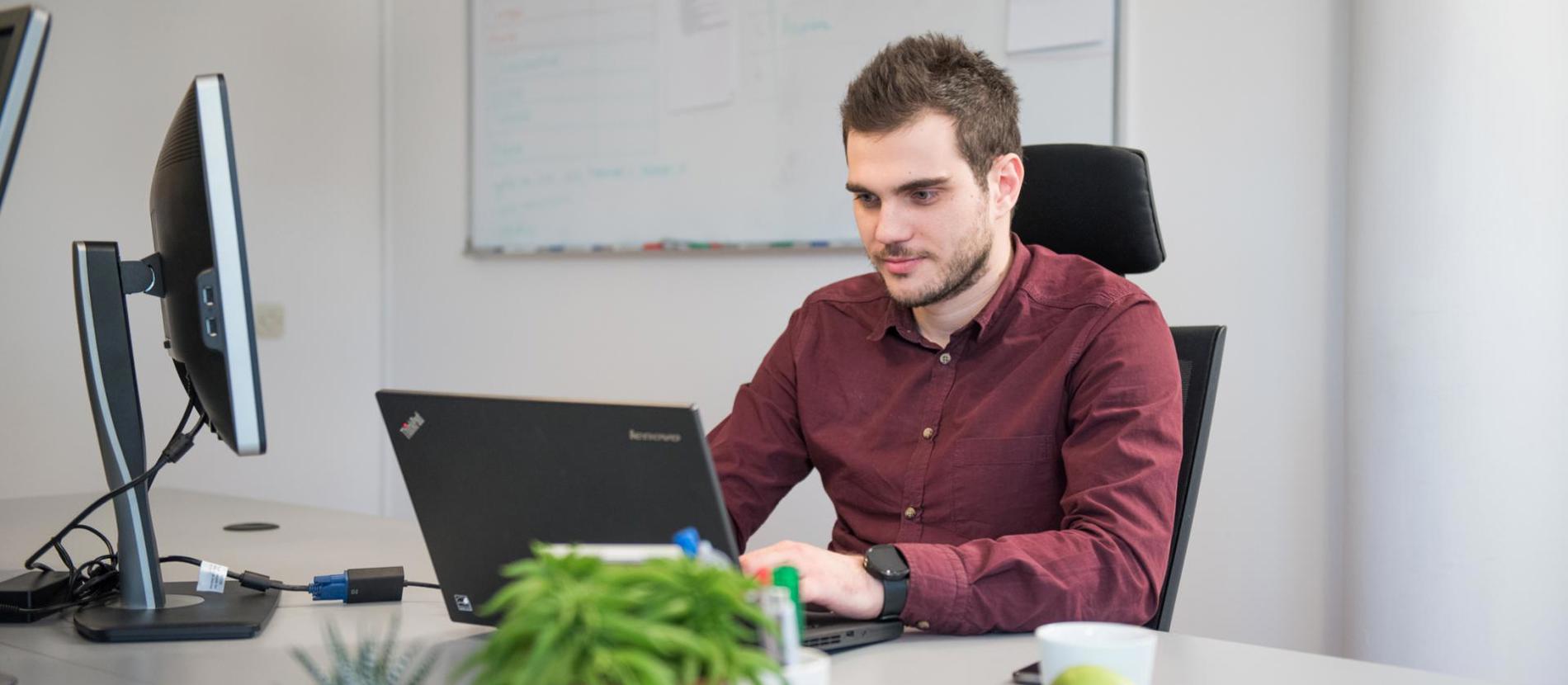 Group of data engineers working together in a bright office.