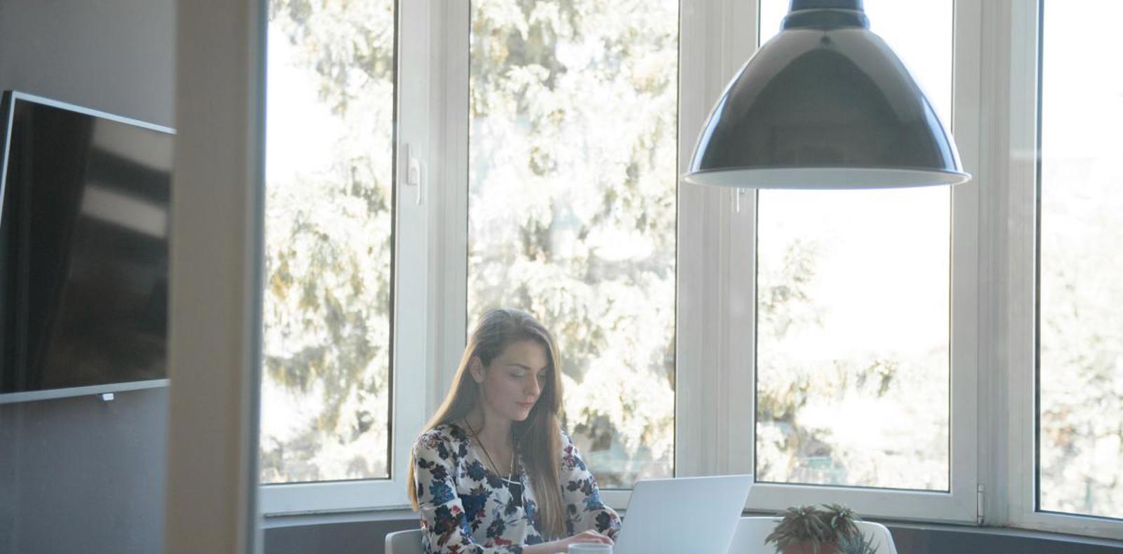 Data scientist working on a laptop in a bright office.