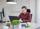 A man working on a laptop at a desk.