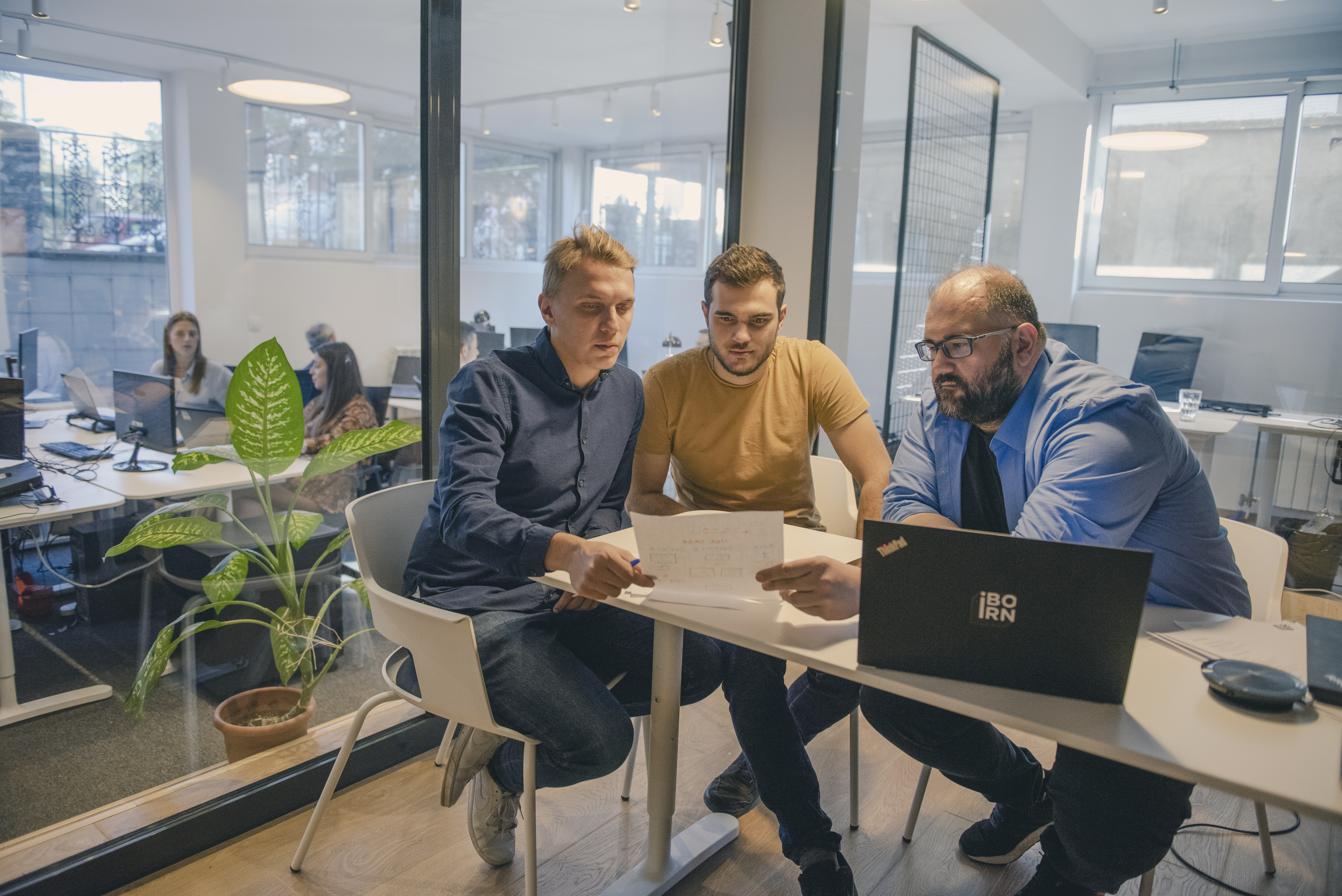 Three software engineers discussing work.