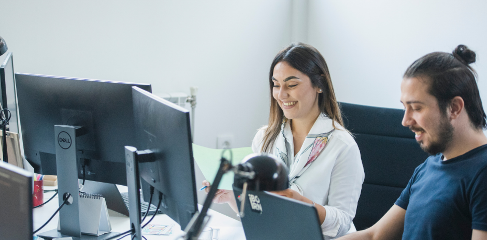 Two colleagues working together on an automated software deployment.