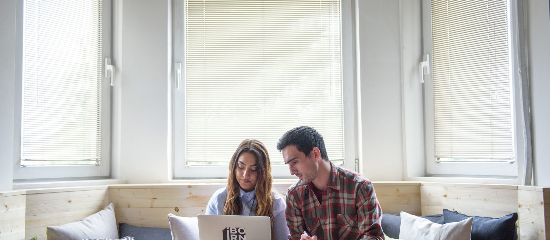 A team of professionals collaborating at a desk in an office, brainstorming and working together to achieve their goals.