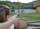A woman focuses intently as she aims her bow at a target in the distance.