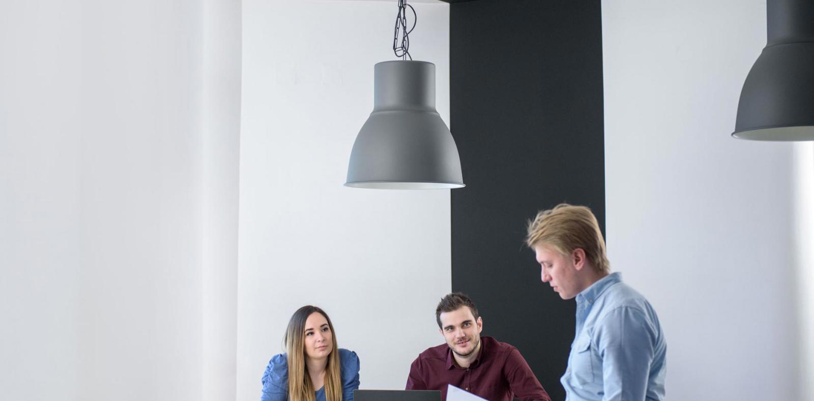 three people having a collaborative session in a professional office environment,