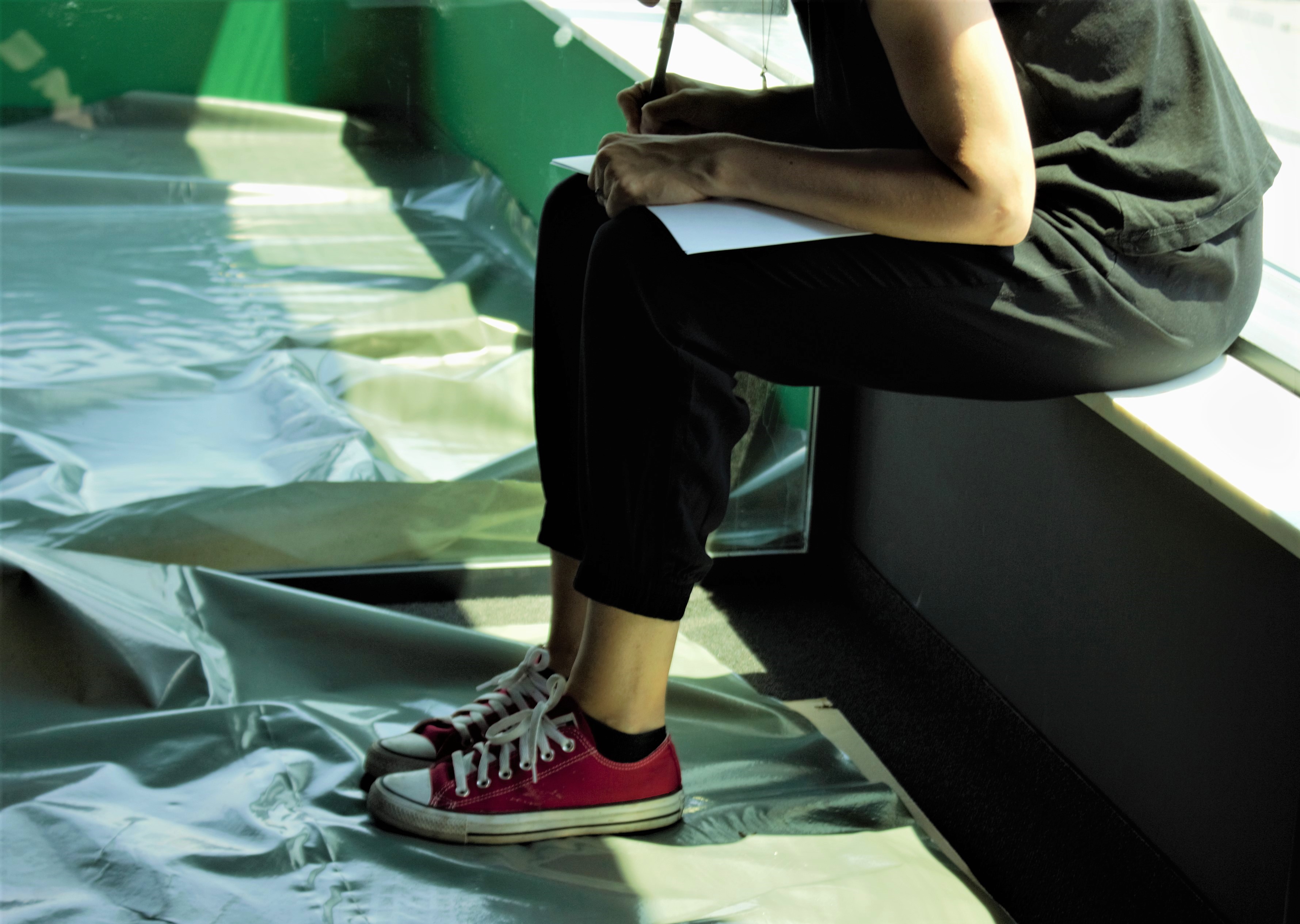 A person sketching and brainstorming a project plan for scalable digital solutions in a modern workspace.