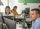 Software engineers working at their desks focused on computers and monitors.
