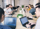 A team of professionals sitting at a table with laptops, likely discussing work or projects.