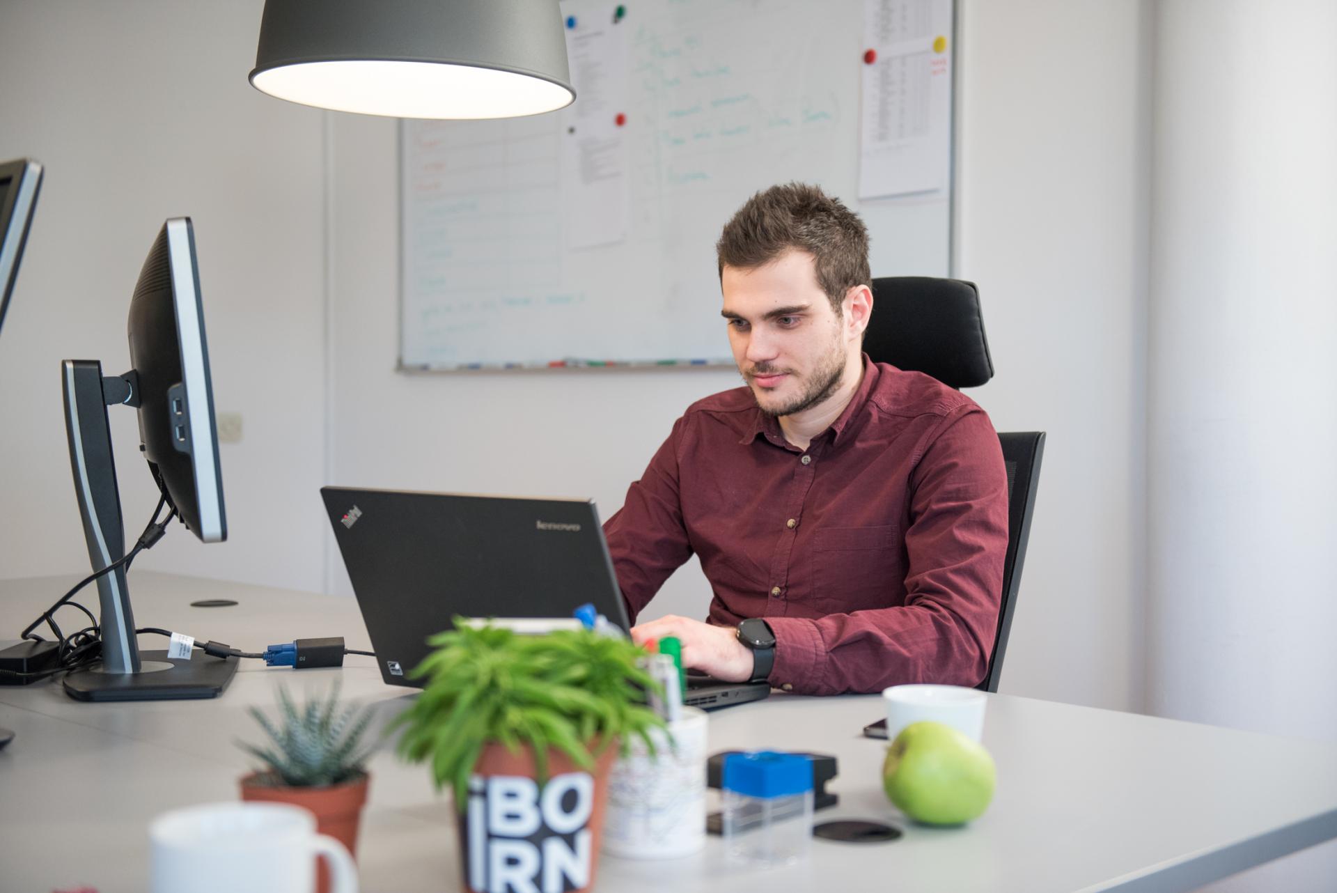 Software engineer working on his desk.