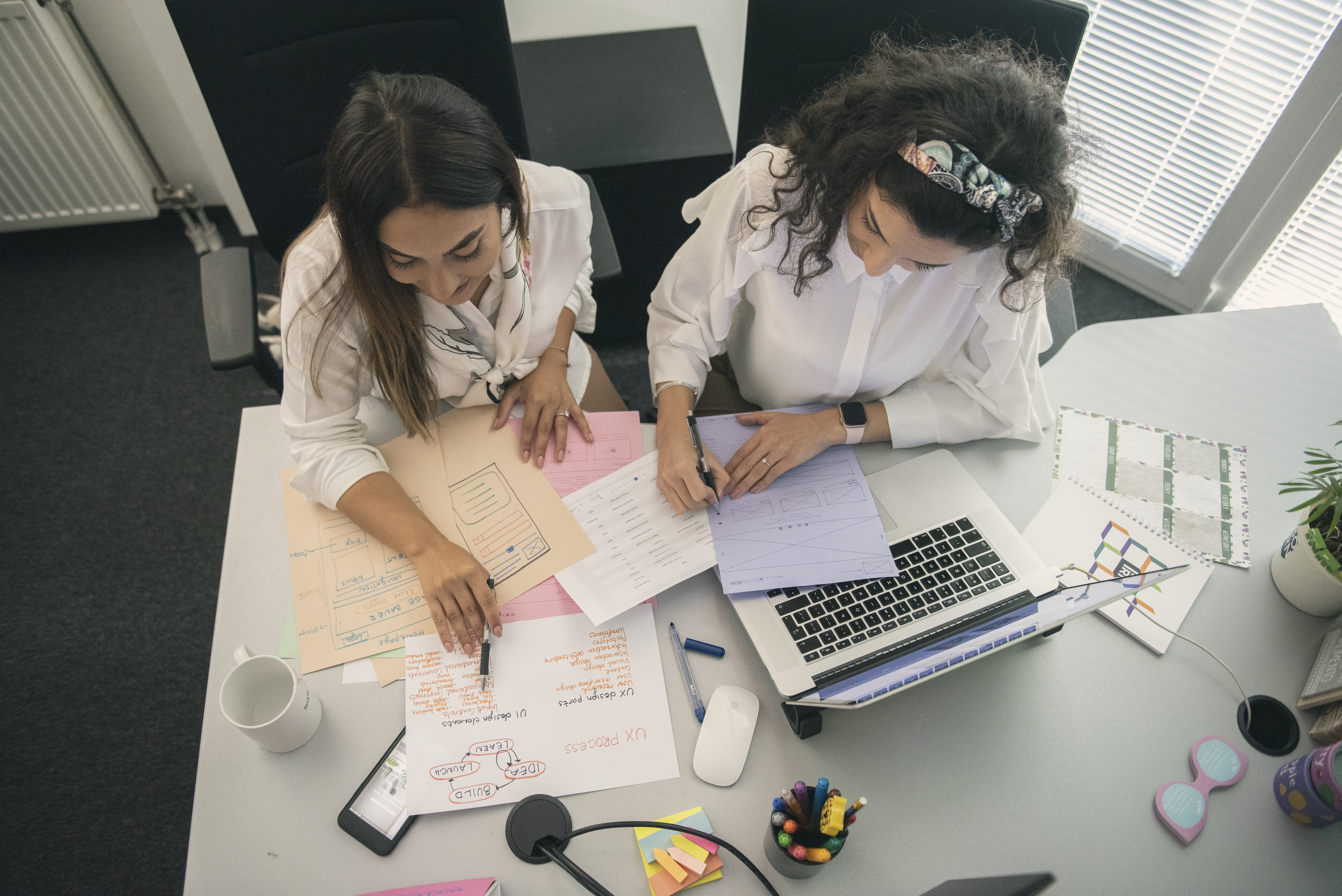 A mobile developer and a UI/UX Designer working on mobile app mockups and prototypes.