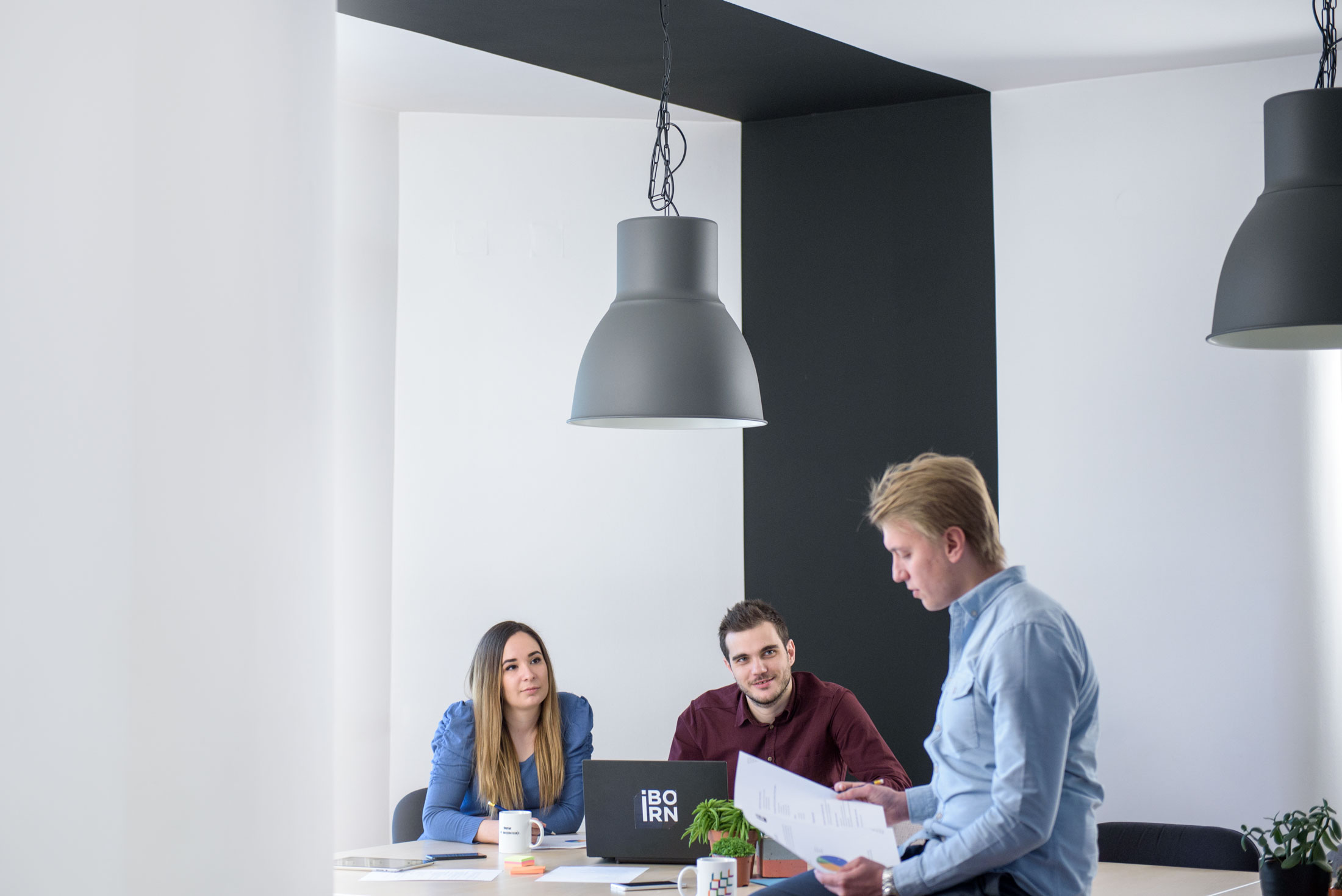 Software developers having a meeting in a bright conference room.