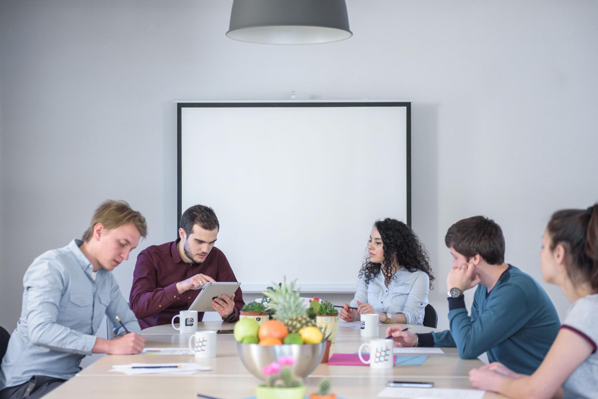 Software engineers having a meeting in a bright conference room. 