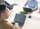 Four people sitting around a table with laptops, engaged in a focused discussion and working together