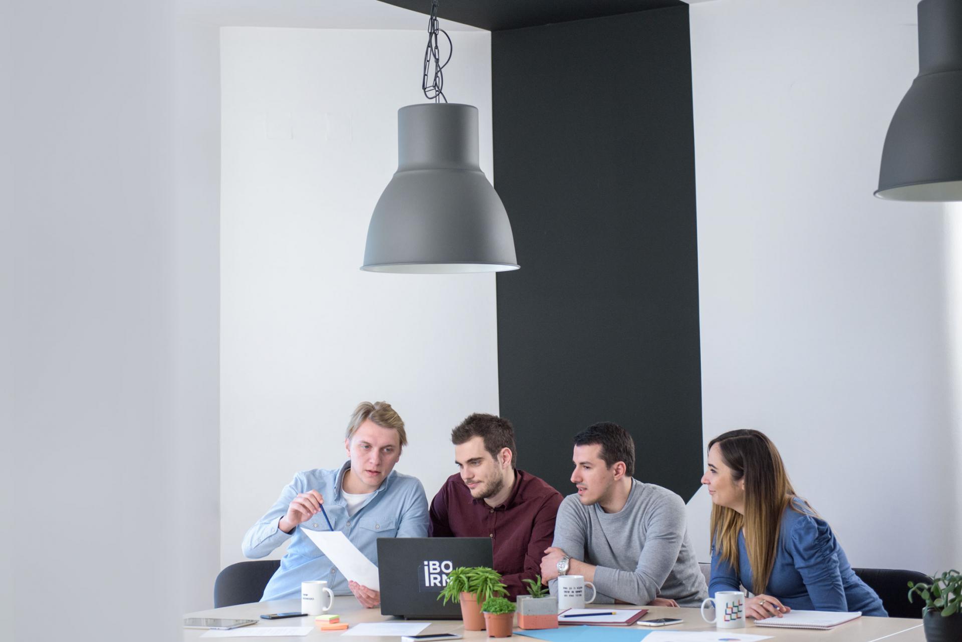 Group of data engineers working together in a bright office.