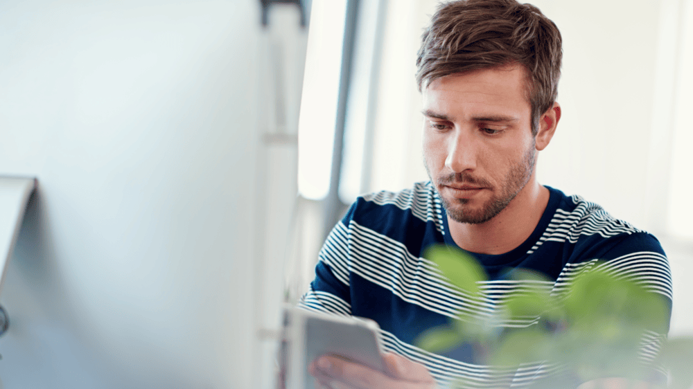 Mobile app developer working in a bright office.
